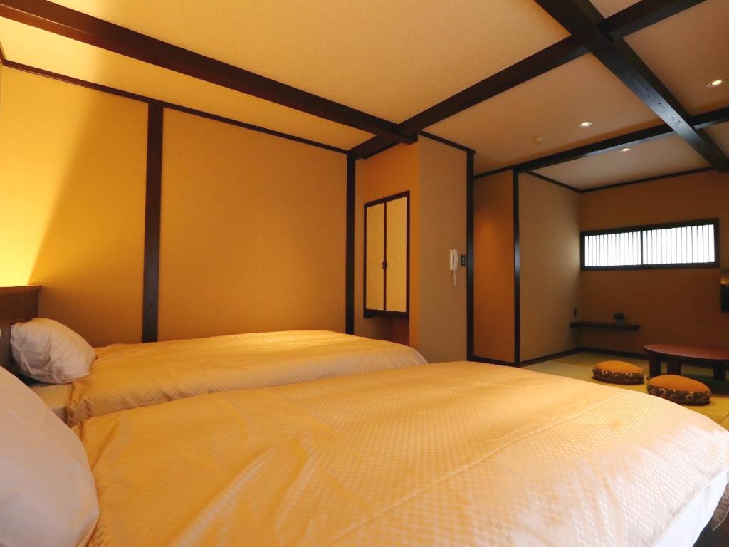 Giường trong phòng chung tại Kii no Matsushima