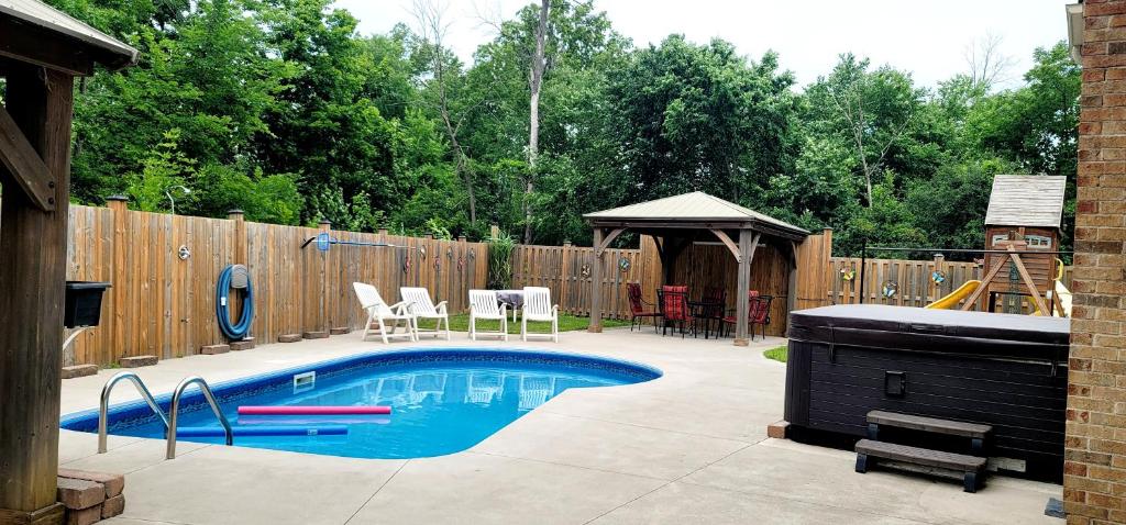 - une piscine dans un jardin avec une clôture en bois dans l'établissement Niagara Falls Villa with Private pool, hottub, water view and Breakfast, à Niagara Falls