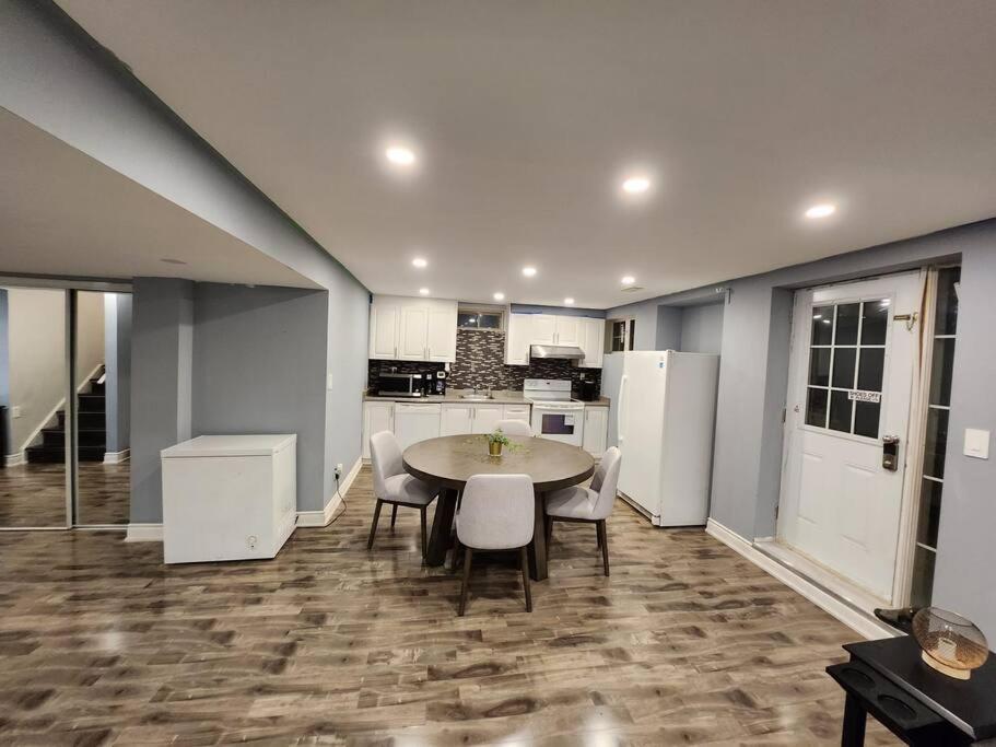 a kitchen with a table and chairs in a room at Adorable 2-Bedoom walkout basement Apartment in Milton