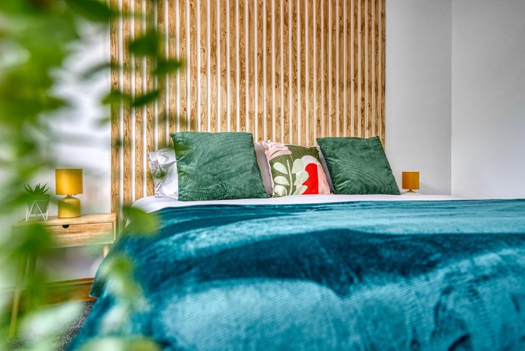 コベントリーにあるAbbey Court - 2 Bedroom Apartment, Parking, JLR, CVT - Coventry Accommodation LTDの青いシーツと枕が備わったベッドのある寝室