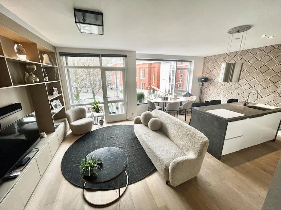 a living room with a couch and a table at Stylish apartment @ city centre in Rotterdam