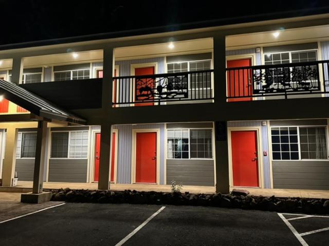 a apartment building with red doors and a balcony at Crater Lake Gateway - Hwy 140 in Klamath Falls