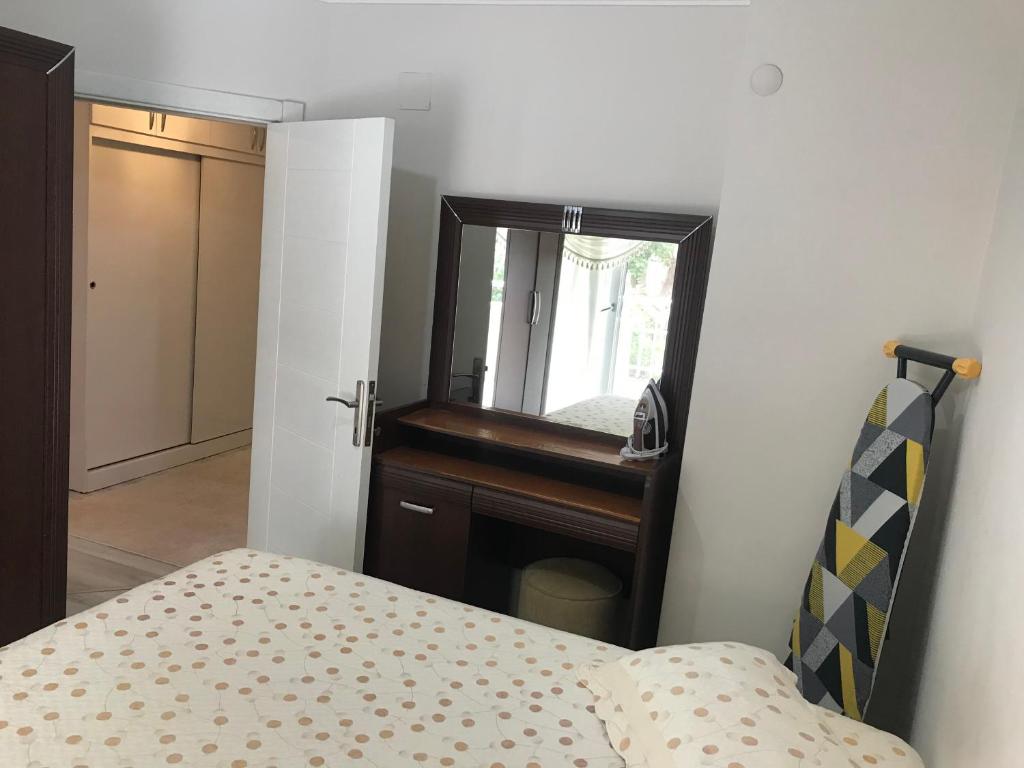 - une chambre avec un lit, un miroir et un piano dans l'établissement Denize 5 dakika, à Alanya