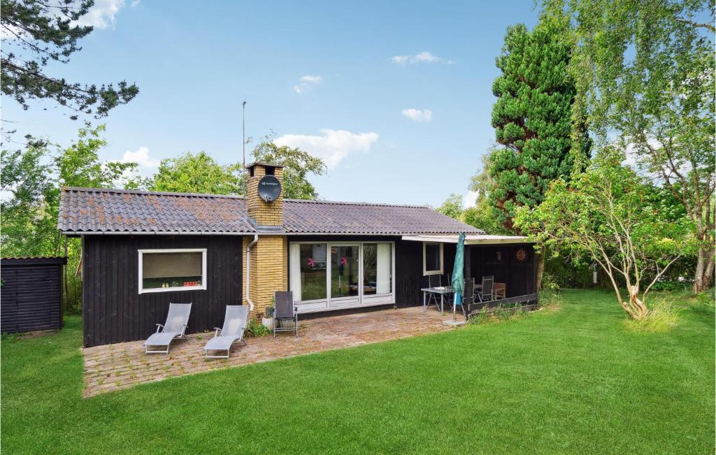 a small house with a patio and a yard at Gorgeous Home In Vejby With Kitchen in Vejby