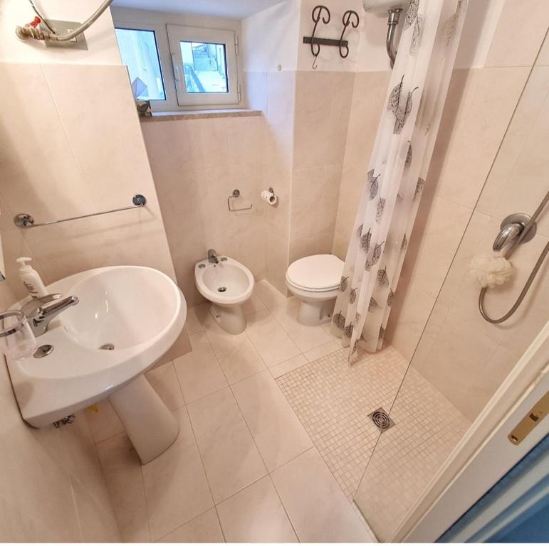 a bathroom with a sink and a toilet and a shower at Casa vacanza Nonno Beppe in Bagnoli del Trigno