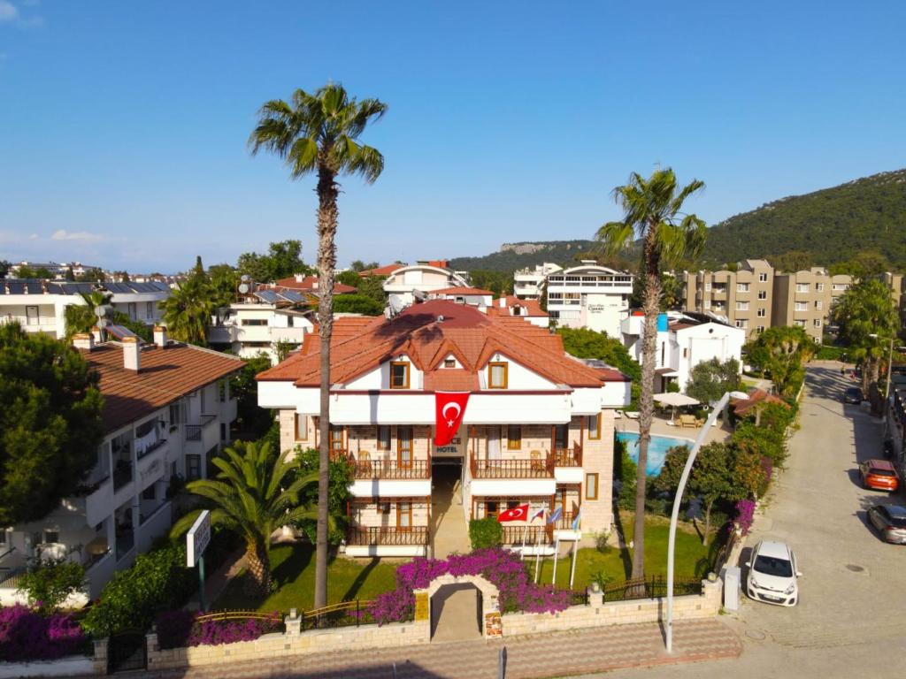 a building with a palm tree in a city at Felice Hotel in Kemer