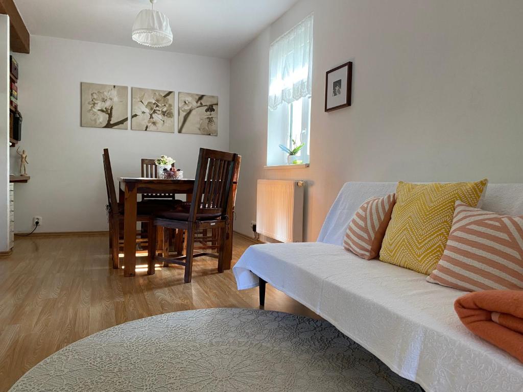 a living room with a couch and a table at Modrá chaloupka in Opařany