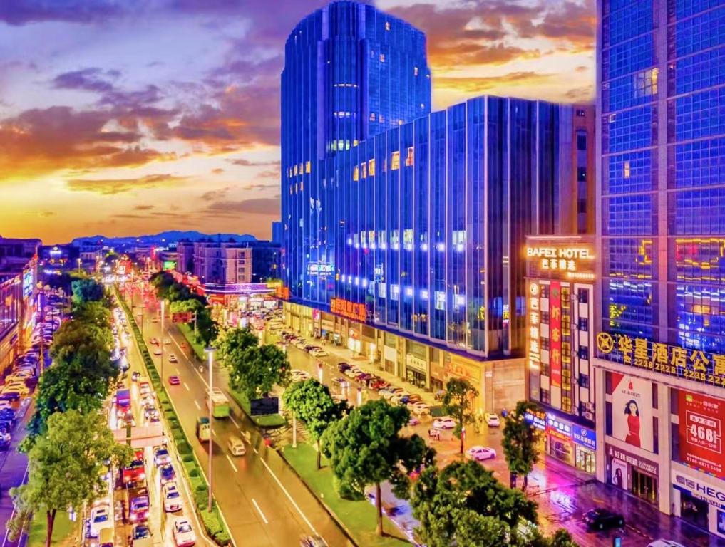a city with tall buildings and a street with cars at Zhongshan Bafei Hotel in Zhongshan