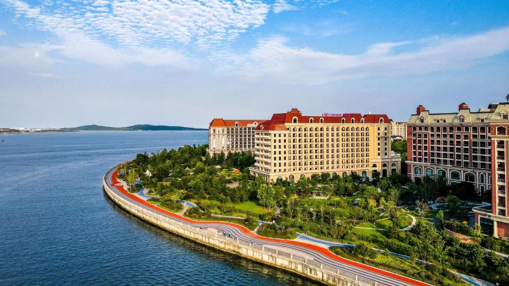 an aerial view of a resort on a body of water at Crowne Plaza QingdaoOrientalMovieMetropolis, an IHG Hotel in Huangdao