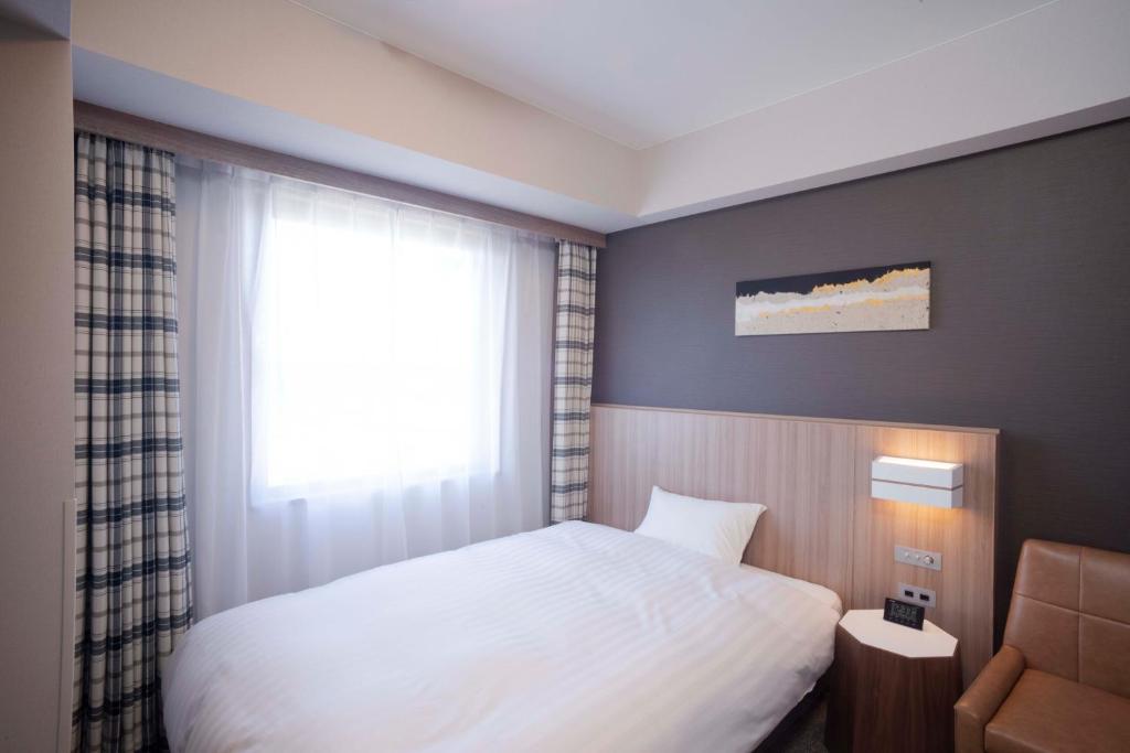Postel nebo postele na pokoji v ubytování Shinrin Hotel
