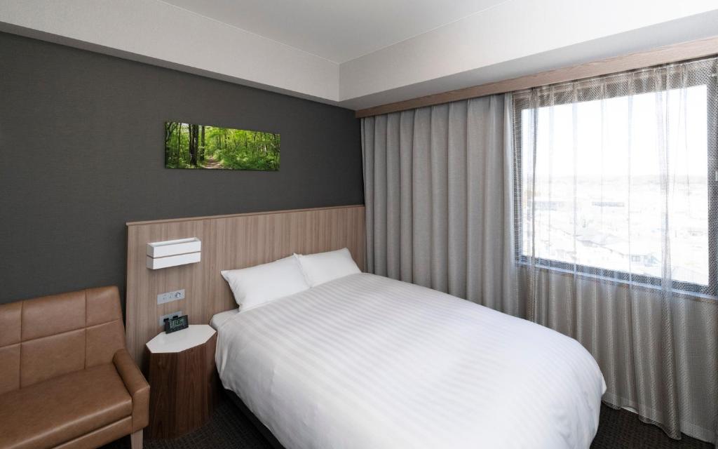 Postel nebo postele na pokoji v ubytování Shinrin Hotel