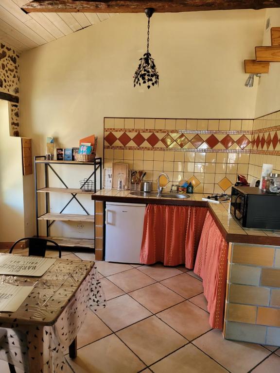 a kitchen with a sink and a counter top at Gîte le Chai in Le Teich