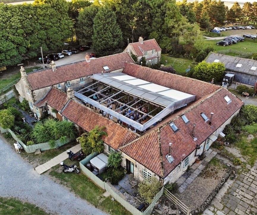 an aerial view of a house with a roof at High Paradise Farm in Thirsk