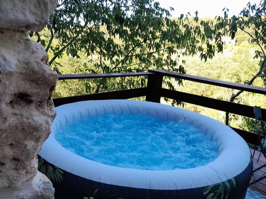 a large hot tub sitting on a patio at COCOON in Lagorce