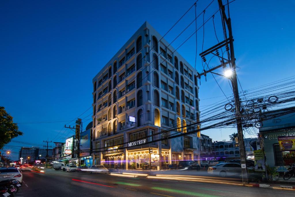 a tall building on a city street at night at Montree Phuket Hotel in Phuket Town