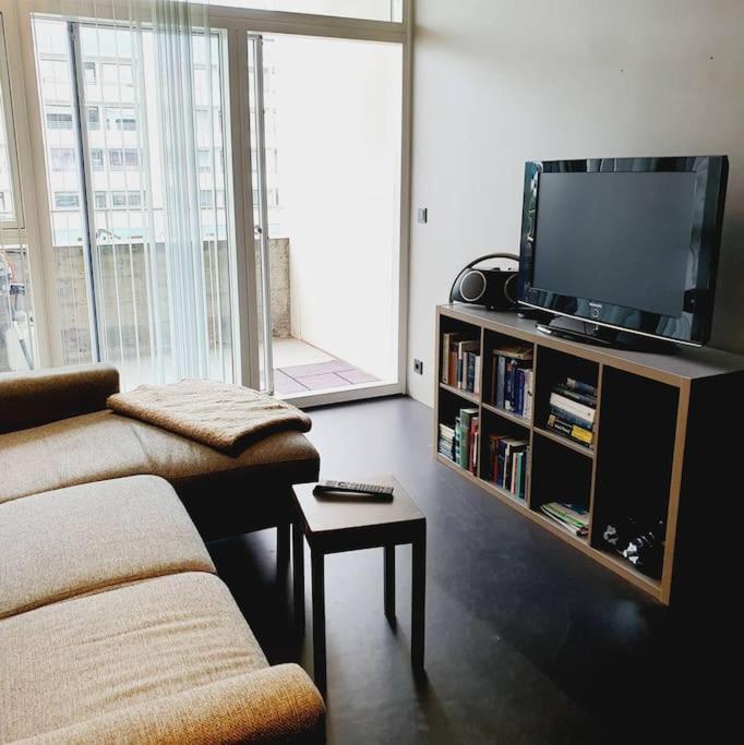 a living room with a couch and a tv at 1-bedroom apartment by city center, free parking in Reykjavík
