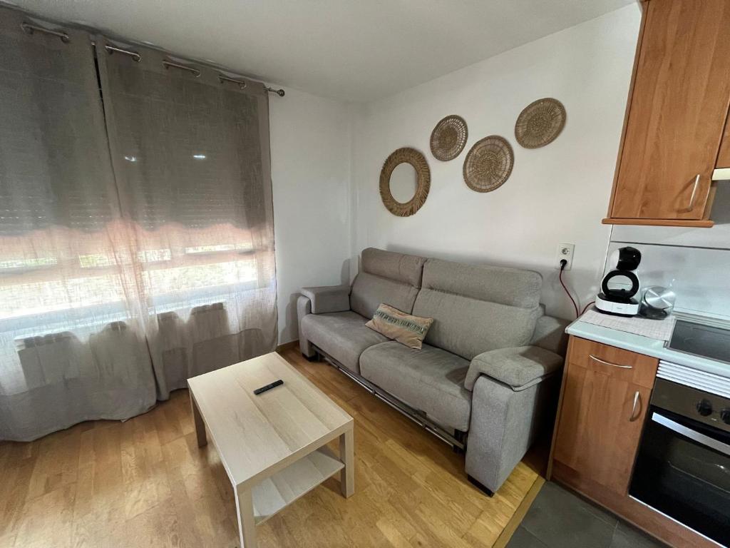 a living room with a couch and a table at NUEVO LLANO JOB&FAMILY in Puebla de Alfindén