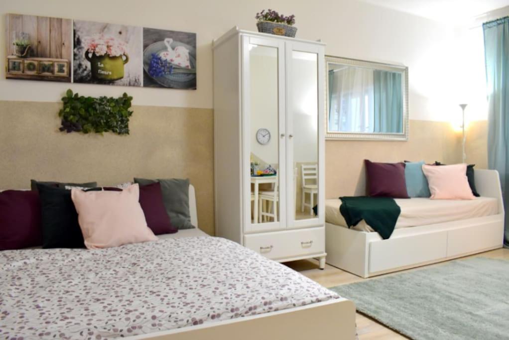 a bedroom with a bed and a white cabinet at Apartment in Prague in Prague