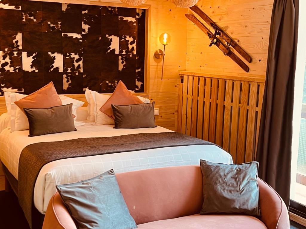 a hotel room with a bed and a couch at Hotel Le Panorama in Le Mont-Dore