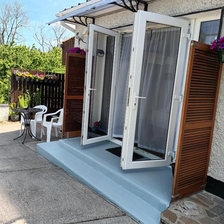 a pair of doors on a house with a table at Kates Place Studio 1 in Donegal