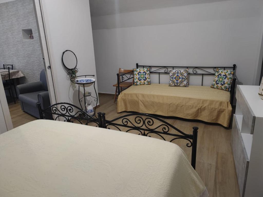 una piccola camera da letto con un letto e una sedia di Dimora Santa Chiara a Manfredonia