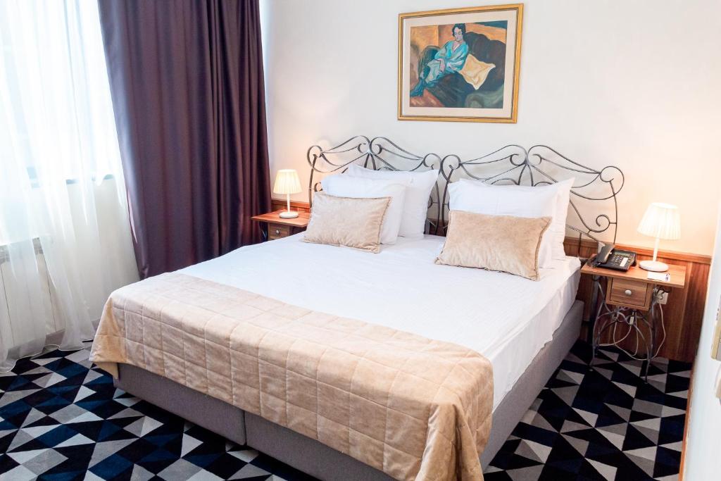 Postel nebo postele na pokoji v ubytování Hotel Art