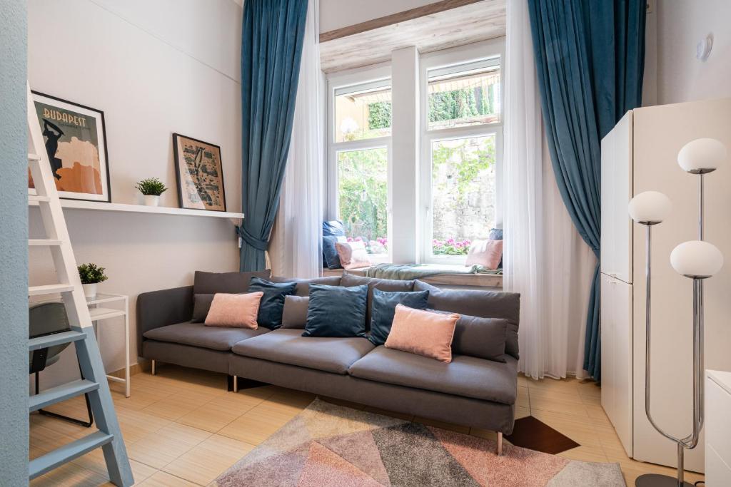 a living room with a couch and a window at Short Trips Apartment in Budapest