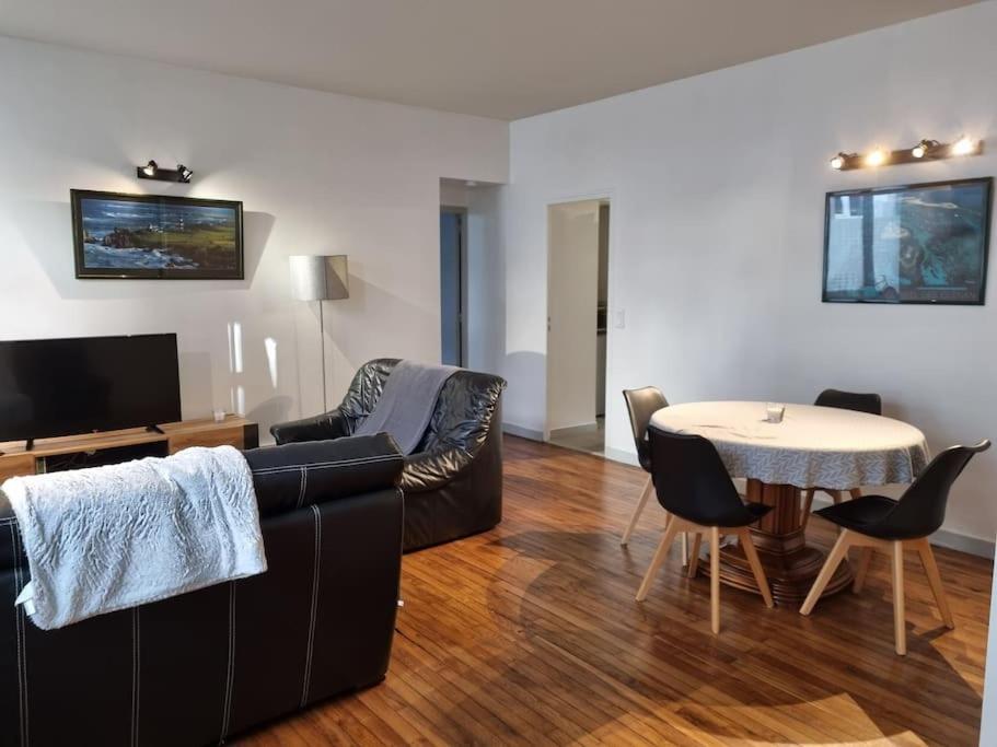 a living room with a couch and a table at Grand appartement près de la Cathédrale de Quimper in Quimper