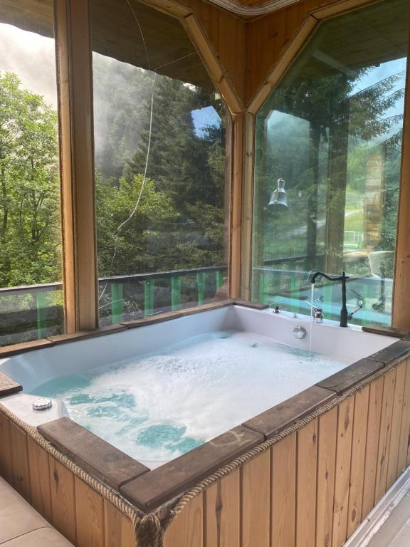 a hot tub in a room with two windows at CENNET DAĞ EVİ in Ayder Yaylasi