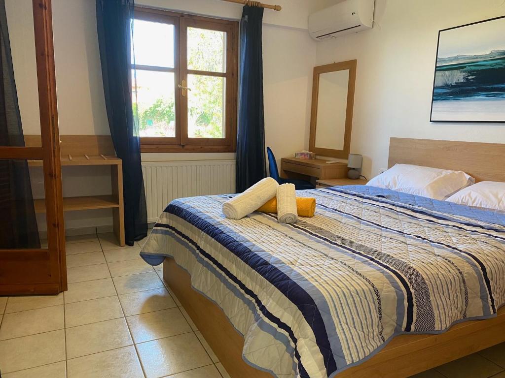 a bedroom with a bed with a blue and white blanket at Villa Lemonia in Malia