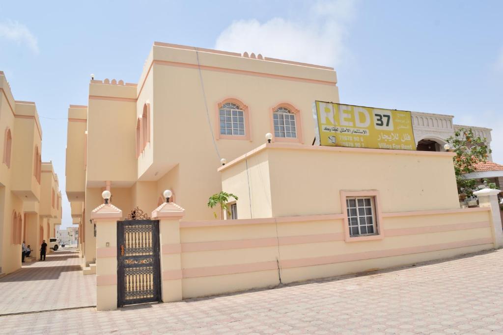a building with a sign on top of it at Red-37 - Bn Breek Villa in Salalah