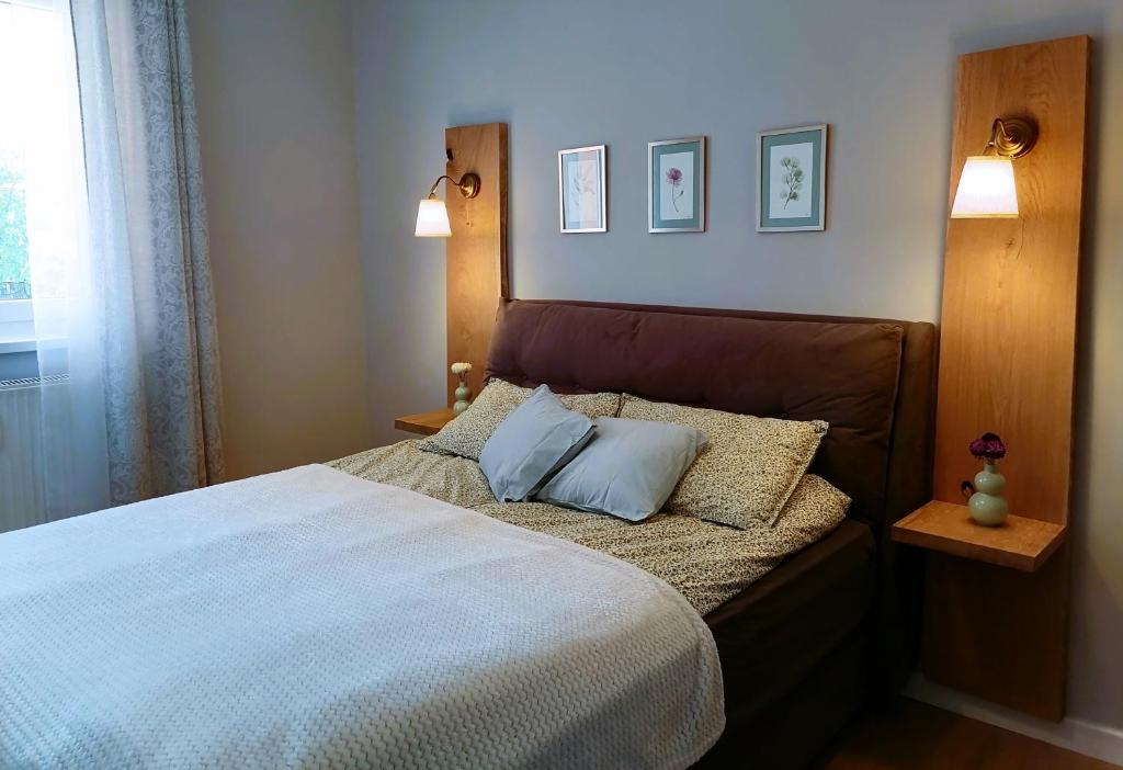 a bedroom with a bed with two pillows on it at Shine Apartman in Szentgotthárd