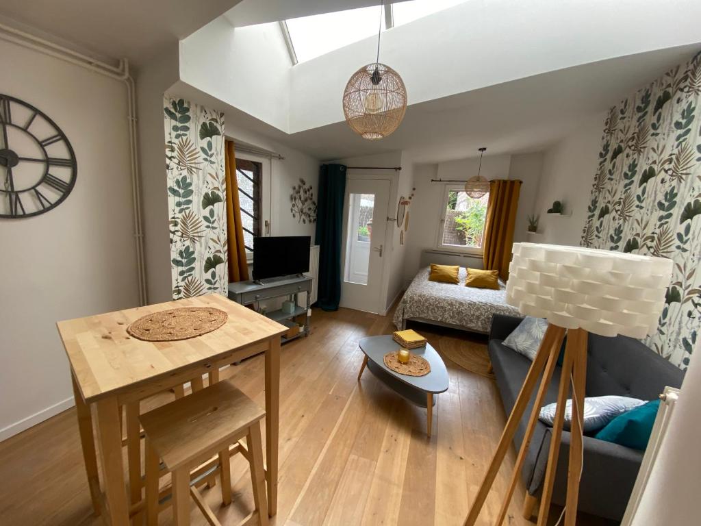 a living room with a couch and a table at Chez Jérôme in Lille