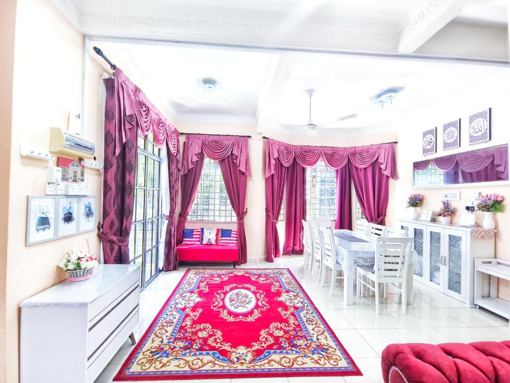 a living room with pink curtains and a red rug at Ujana Damai - Cosy 5 bedrooms near UMT UNISZA in Kuala Terengganu