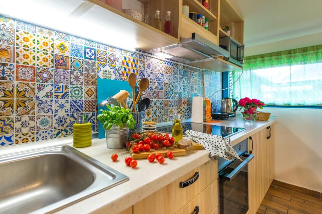 a kitchen with a sink and vegetables on a counter at Boho House 4 in camp Terme Catez in Čatež ob Savi