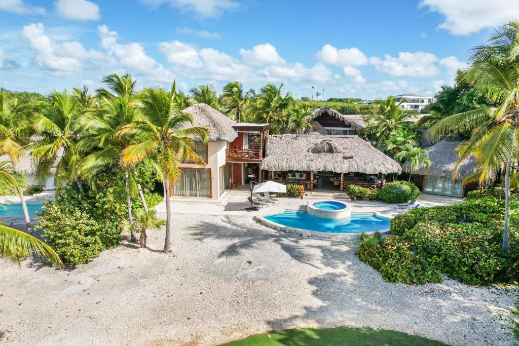 an aerial view of a resort with a pool and palm trees at 5BR Cap Cana Villa with Ocean & Golf Views, Chef, Maid, Butler, Pool, Jacuzzi, and Beach Club Access in Punta Cana