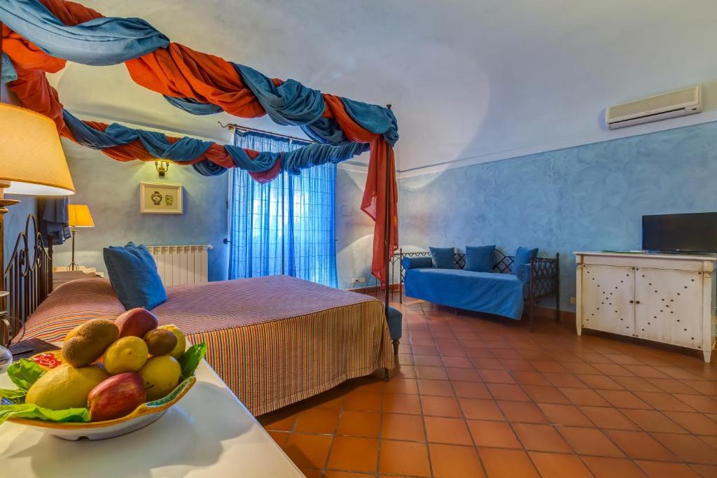 a hotel room with a bowl of fruit on a table at La Casa delle Monache Country Resort in Motta Camastra