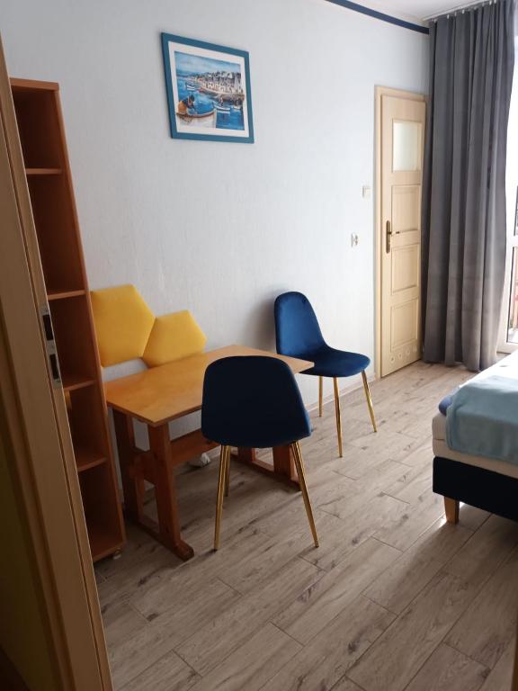 a room with a desk and a chair and a bed at Pokoje Przy Plaży- Morska 26 in Władysławowo