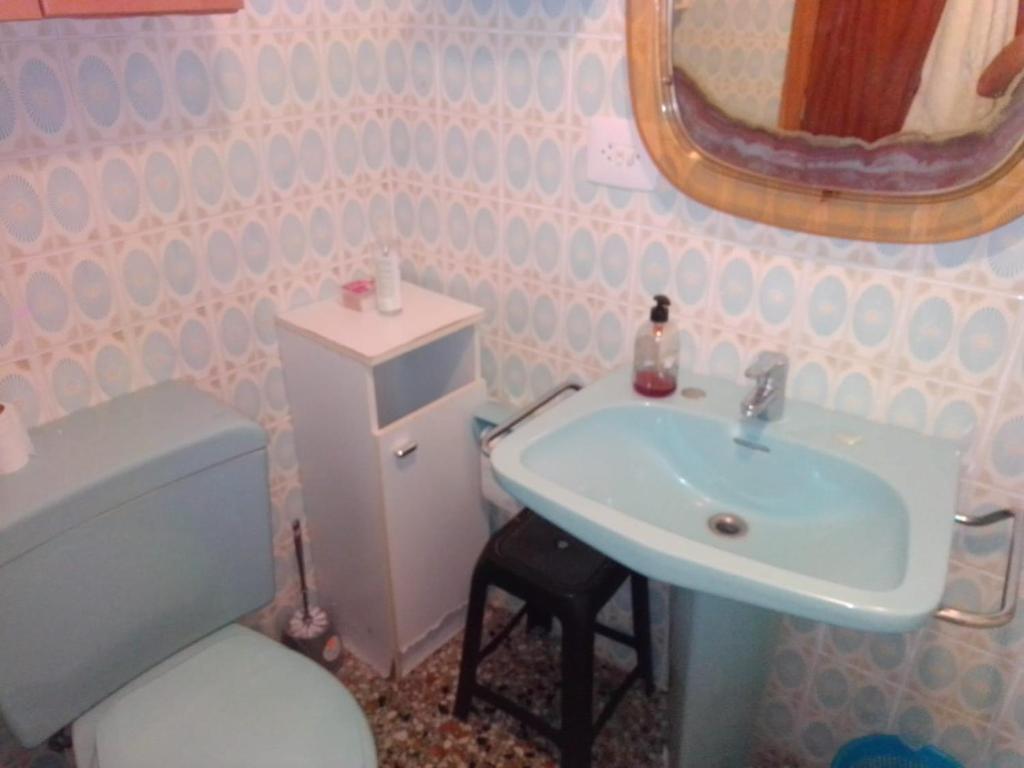 a bathroom with a sink and a toilet and a mirror at Habitaciones playa de Gandía in Playa de Gandia