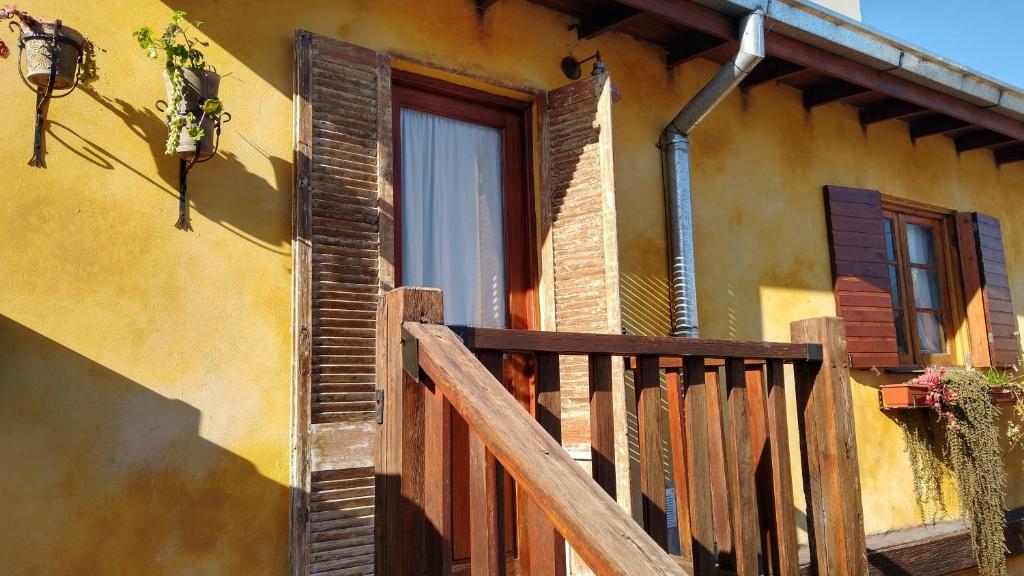 a house with a wooden balcony and a window at Villa Escondida in Mar del Plata