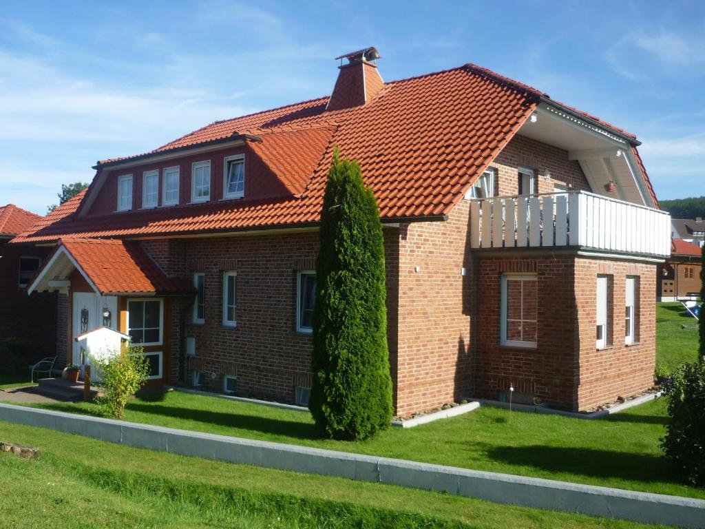 een stenen huis met een oranje dak bij Ferienwohnung Naturblick in Schönhagen