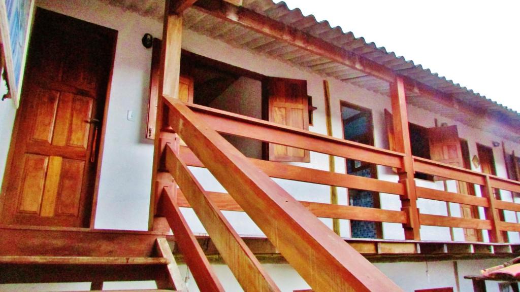 a staircase leading to a building with wooden doors at Pousada Paraty in Paraty