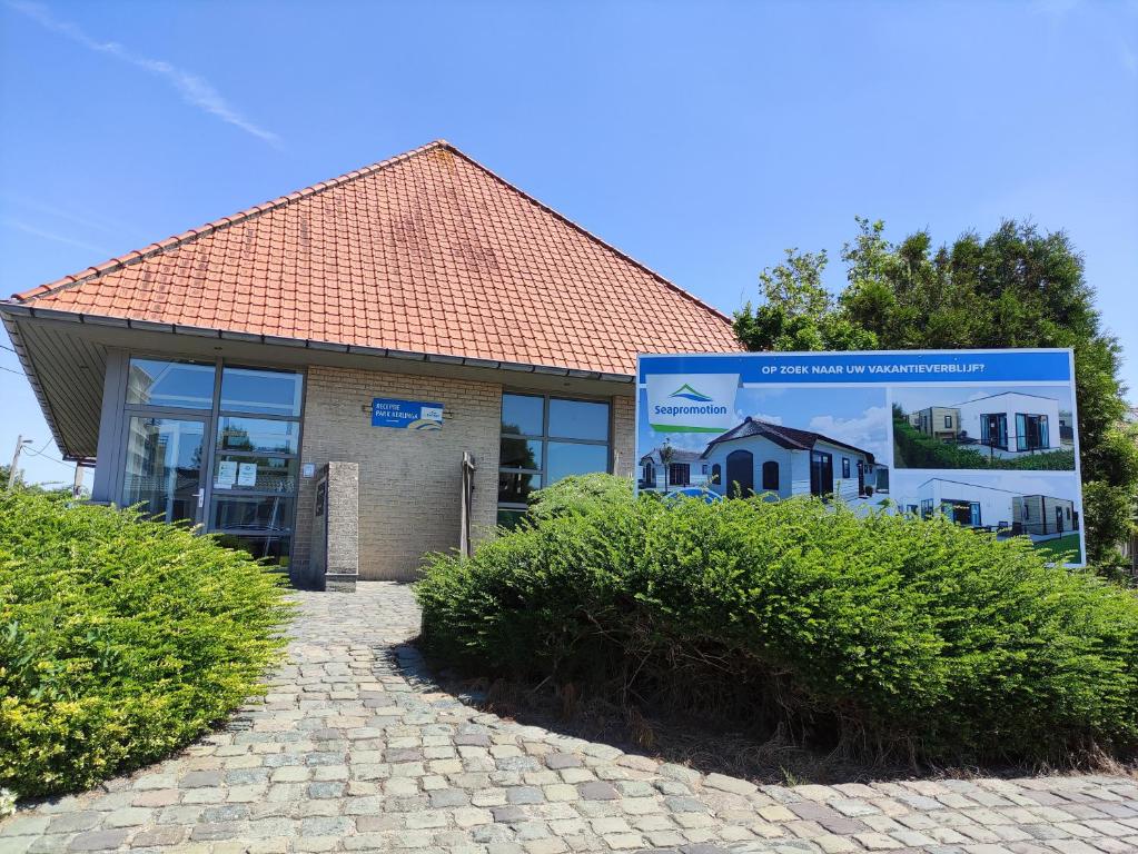 a building with a sign in front of it at Camping Urlaub Bredene Belgien in Bredene
