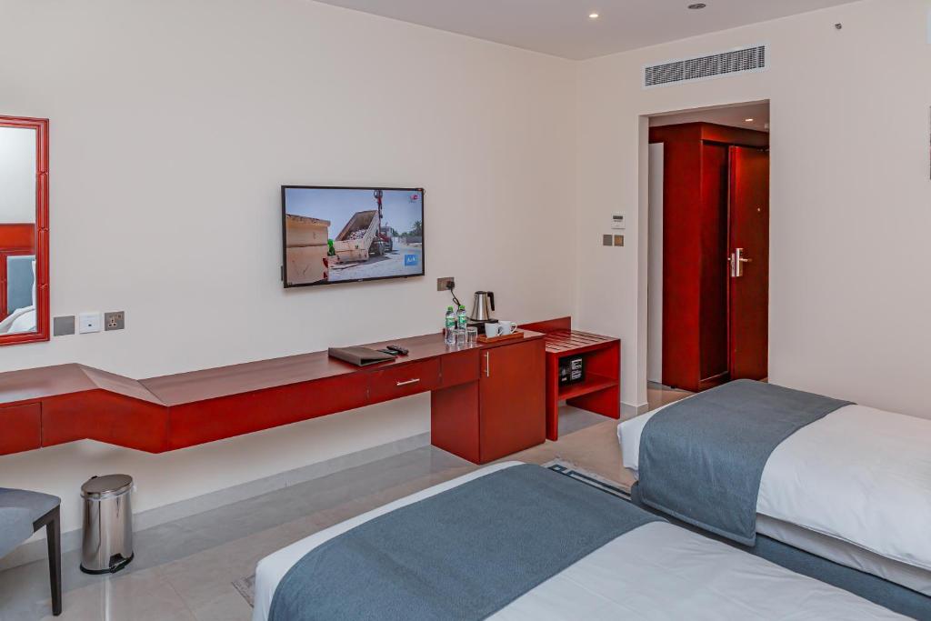 Postel nebo postele na pokoji v ubytování Salalah International Hotel