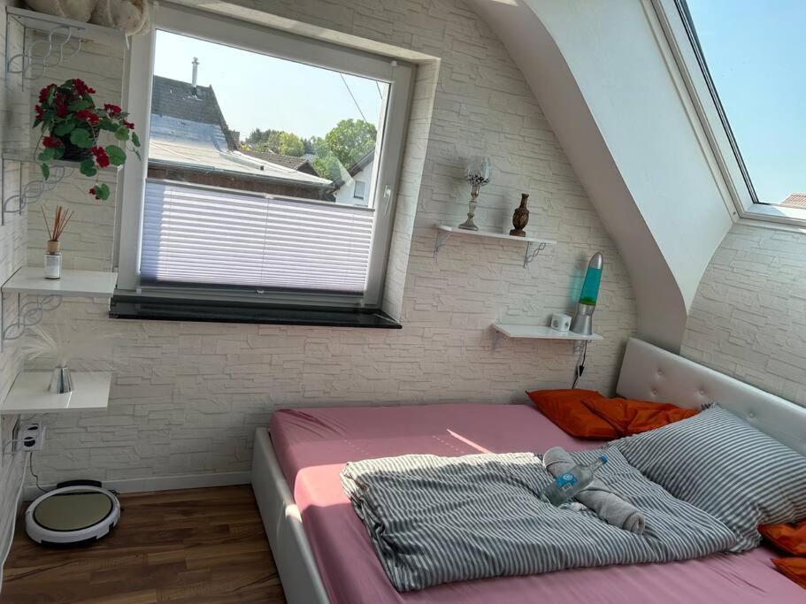 ein kleines Bett in einem Zimmer mit Fenster in der Unterkunft Zimmer HomeOffice Küche WLAN TV mit Terrasse&Grill +Fahrrad 