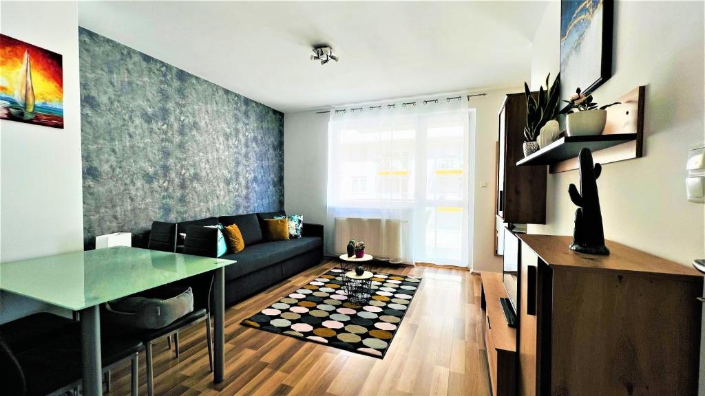 a living room with a couch and a table at Happy Living Apartment w Balcony in Budapest