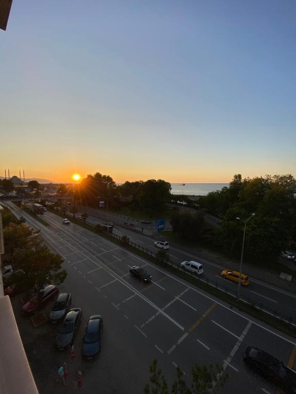 a street with cars parked in a parking lot at sunset at Kültür Suite meydan in Trabzon