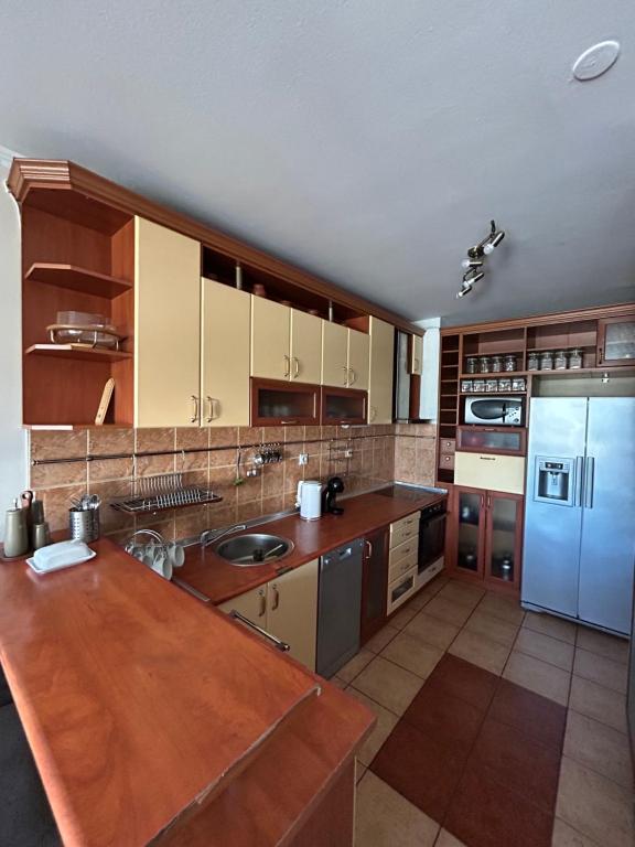 a kitchen with wooden counters and a blue refrigerator at Baroque-style apartment in Štip