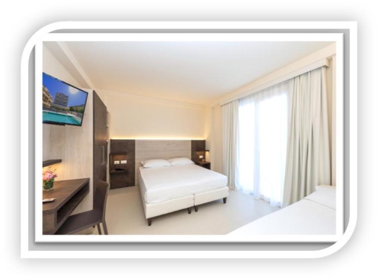 A bed or beds in a room at Hotel Carducci