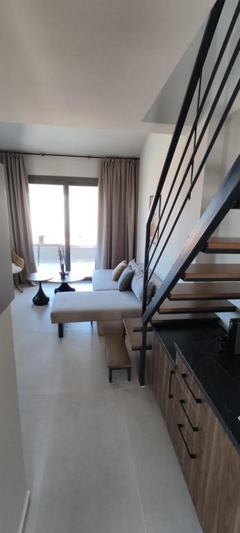 a bedroom with a bed and a staircase in it at Welcome Inn in Paleo Tsifliki
